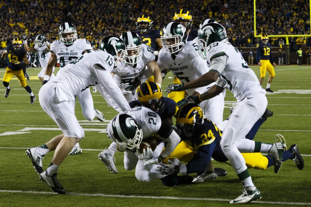 Oct 17, 2015; Ann Arbor, MI, USA; Michigan State Spartans defensive back Jalen Watts-Jackson (20) dives into the end zone for a game winning touchdown as the clock runs out in the fourth quarter against the Michigan Wolverines at Michigan Stadium. Michigan State 27-23. Mandatory Credit: Rick Osentoski-USA TODAY Sports