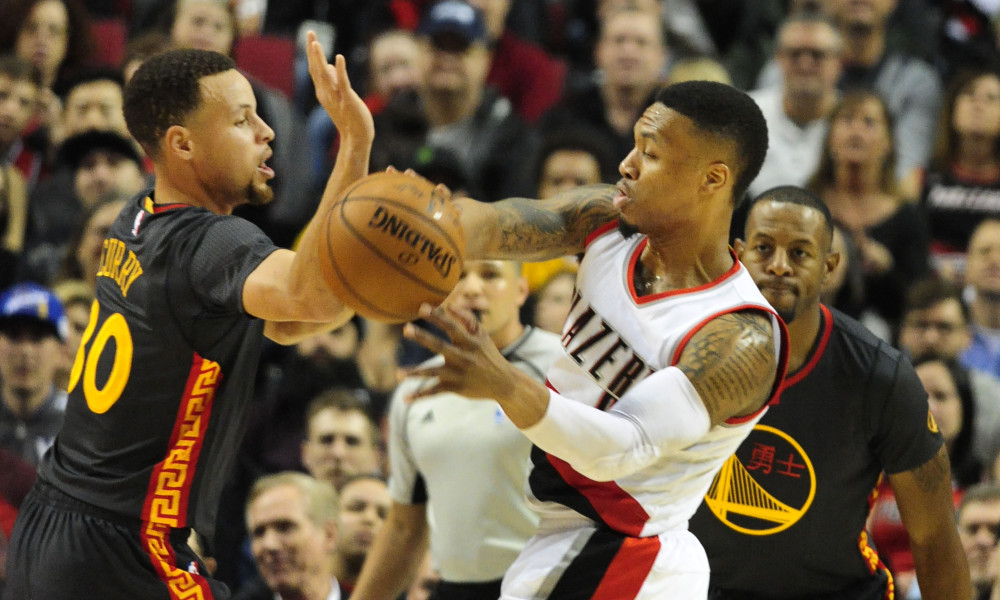 Feb 19, 2016; Portland, OR, USA; Portland Trail Blazers guard Damian Lillard (0) passes the ball on Golden State Warriors guard Stephen Curry (30) during the first quarter of the game at the Moda Center at the Rose Quarter. Mandatory Credit: Steve Dykes-USA TODAY Sports