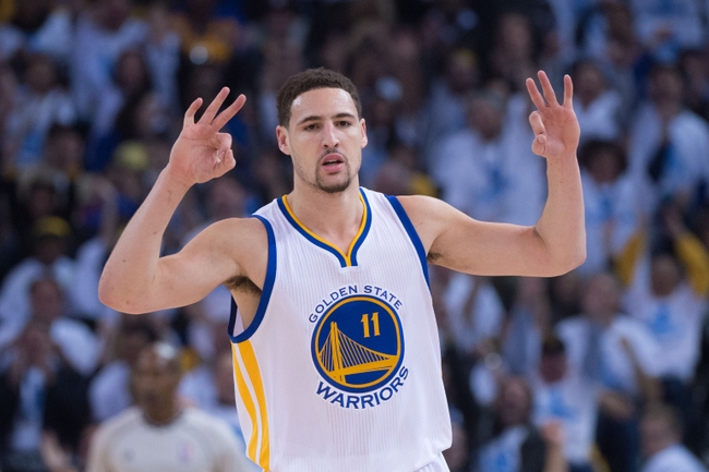 January 5, 2015; Oakland, CA, USA; Golden State Warriors guard Klay Thompson (11) celebrates after making a three-point basket during the first quarter against the Oklahoma City Thunder at Oracle Arena. The Warriors defeated the Thunder 117-91. Mandatory Credit: Kyle Terada-USA TODAY Sports