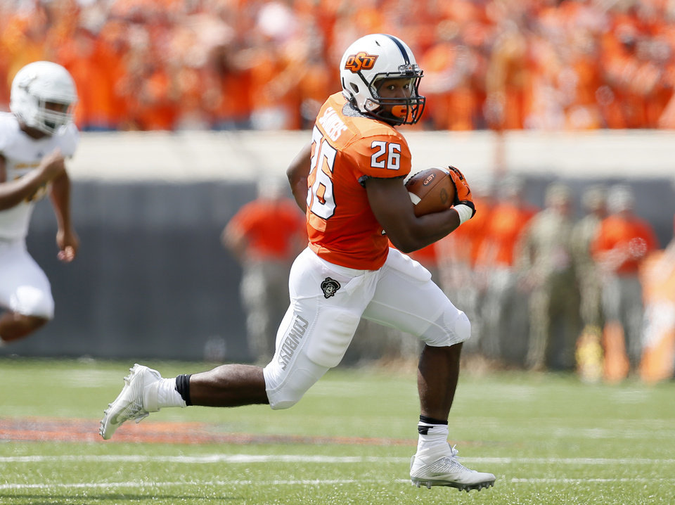 Oklahoma State's Barry J Sanders (26) returns a punt return during the college football game between the Oklahoma State Cowboys (OSU) and the Southeastern Louisiana Lions at Boone Pickens Stadium in Stillwater, Okla., Saturday, Sept. 12, 2015. Photo by Sarah Phipps, The Oklahoman