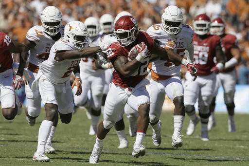 Oklahoma running back Samaje Perine (32) runs against Texas cornerback Kris Boyd (2) during the first half of an NCAA college football game in Dallas Saturday, Oct. 8, 2016. (AP Photo/LM Otero)