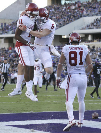 Oklahoma wide receiver Dede Westbrook (11) celebrates catching a touchdown pass with quarterback Baker Mayfield (6) as wide receiver Mark Andrews (81) looks on during the first half of an NCAA college football game against TCU, Saturday, Oct. 1, 2016, in Fort Worth, Texas. (AP Photo/LM Otero)